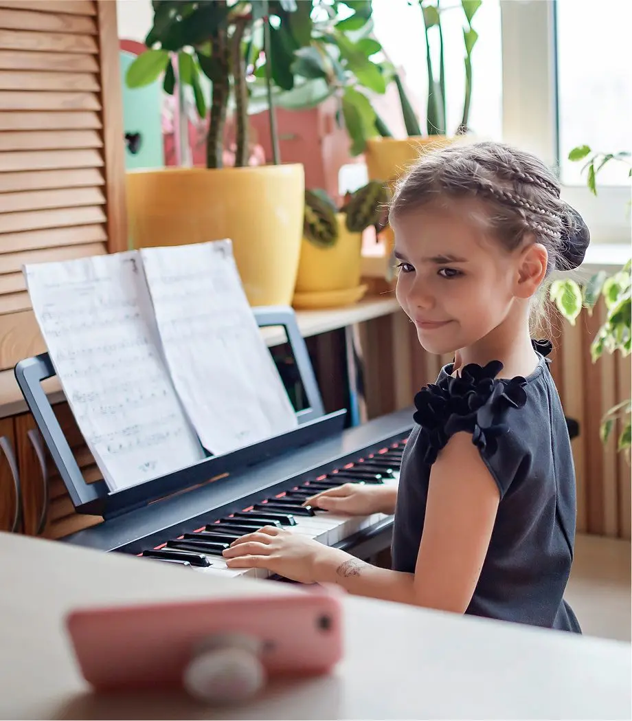 Child playing keyboard at home
