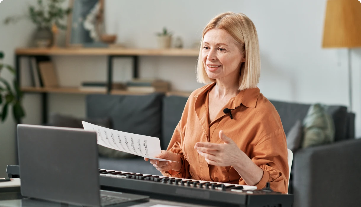 Senior woman playing keyboard at home