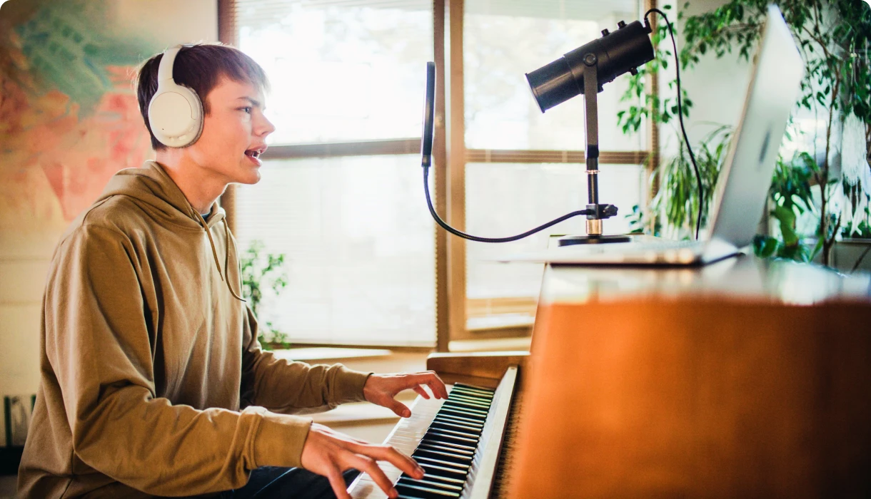 Musician recording vocals at home studio